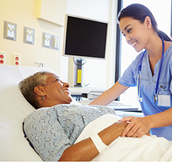 Nurse Talking To Senior Woman In Hospital Room